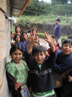 Clean hands! The orange tubing runs the water to the tank in the classroom. The kids are standing around the pila.